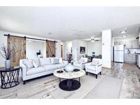 Open living space with barn door, updated flooring and contemporary decor at 300 S Clinton St # 8C, Denver, CO 80247