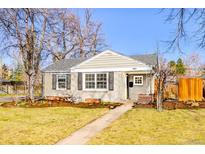 Charming single-story home with neat landscaping, well-maintained lawn, and inviting curb appeal at 860 Magnolia St, Denver, CO 80220