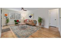 Bright living room with hardwood floors, large windows, and stylish decor with ample natural light at 860 Magnolia St, Denver, CO 80220