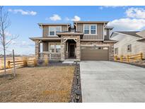 Two-story house with stone accents and a large driveway at 270 Maddox Ln, Erie, CO 80516