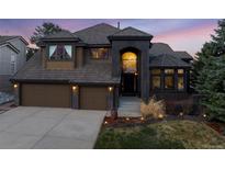 Stunning two-story home featuring a symmetrical facade, two-car garage, and beautiful desert landscaping at 34 Amaranth Dr, Littleton, CO 80127