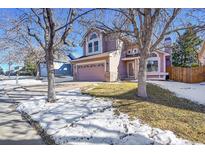 Two-story house with beige siding, attached garage, and landscaping at 18576 E Saratoga Pl, Aurora, CO 80015