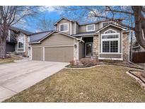 Charming two-story home featuring a two-car garage, stone accents and a well-manicured lawn at 5311 S Danube Ct, Centennial, CO 80015