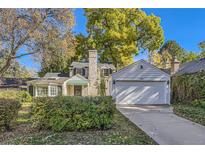 House exterior features a brick facade, attached garage and landscaping at 350 Cherry St, Denver, CO 80220