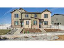 Beautiful townhome featuring a landscaped front yard and inviting entryway at 1296 S Algonquian, Aurora, CO 80018