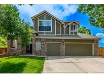 Charming two-story home features a three-car garage, stone accents, lush lawn, and inviting curb appeal at 1588 W 111Th Ave, Northglenn, CO 80234