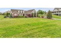 Expansive front yard with charming two-story home and lush landscaping at 8236 S Ireland Way, Aurora, CO 80016