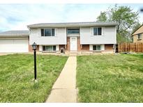 Charming two-story home with light siding, brick accents, and a well-manicured front lawn at 465 Salem St, Aurora, CO 80011