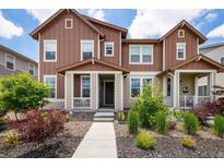 Charming two-story home with brown and beige siding and landscaped front yard at 1125 Anker Dr, Erie, CO 80516