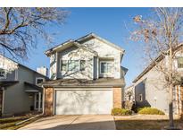 Charming two-story home with a brick-accented garage and well-maintained landscaping at 2217 S Nome Ct, Aurora, CO 80014