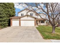 Charming two-story home with a three-car garage, well-maintained lawn, and mature trees at 5596 S Urban St, Littleton, CO 80127
