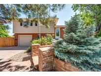 Charming two-story home featuring a brick facade, well-maintained landscaping, and an attached garage at 4660 E Briarwood Pl, Centennial, CO 80122
