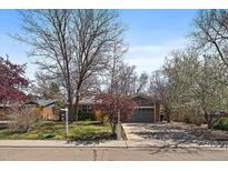 Charming single-story home with well-maintained lawn, mature trees, and an attached two-car garage at 1746 Shavano St, Longmont, CO 80504