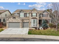 Beautiful two-story brick home featuring a three-car garage and well-maintained landscaping at 11930 E Lake Cir, Greenwood Village, CO 80111