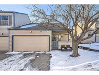Charming townhouse featuring a front yard, attached garage, and covered entrance at 1773 S Union Blvd, Lakewood, CO 80228