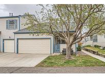 Charming townhome with attached garage, front lawn, mature tree and covered entry at 1773 S Union Blvd, Lakewood, CO 80228
