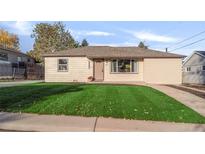 Charming single-story home with well-maintained lawn and a cozy front porch at 709 S Wolcott Ct, Denver, CO 80219