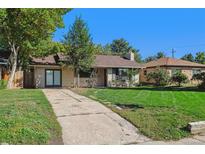 Ranch style home with a large yard and driveway at 4684 S Lincoln St, Englewood, CO 80113