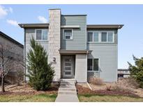 Charming two-story home featuring a modern exterior with stone accents and professionally landscaped yard at 3368 Cranston Cir, Highlands Ranch, CO 80126