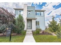 Charming two-story home with a well-manicured lawn and inviting stone-accented entrance at 3368 Cranston Cir, Highlands Ranch, CO 80126