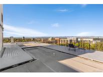 Expansive roof deck featuring lounge seating and panoramic city views at 740 N Pearl St # 203, Denver, CO 80203