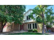 Charming brick home with a red front door and well-maintained front yard at 16639 E Berry Ln, Centennial, CO 80015