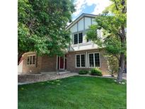 Charming two-story home with a well-maintained lawn and mature trees at 16639 E Berry Ln, Centennial, CO 80015