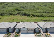 View of the beautiful home exterior with a well-maintained roof and landscaping at 6835 Surrey Trl, Littleton, CO 80125
