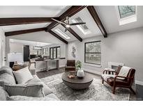 Open-concept living room features vaulted ceilings and seamless flow at 11861 E Yale Ct, Aurora, CO 80014