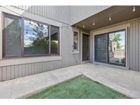 Enclosed patio with sliding glass door and string lights for outdoor entertaining at 1233 S Yosemite Way # 74, Denver, CO 80247
