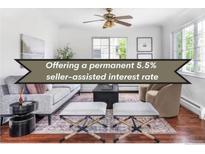 Bright living room with a ceiling fan, modern decor, and comfortable seating arrangement at 6673 S Benton St, Littleton, CO 80123