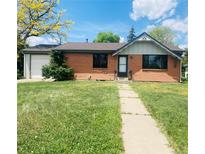 Charming brick home featuring a well-maintained front yard and a quaint entrance walkway at 153 S Pierce St, Lakewood, CO 80226