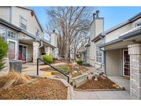 Charming condo exterior featuring landscaped walkway, mature trees, and neutral color scheme at 4301 S Pierce St # 6D, Littleton, CO 80123