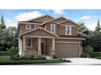 Two-story house with brown siding, stone accents, and a two-car garage at 210 Paloma Way, Elizabeth, CO 80107