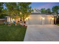 Charming brick home boasts a spacious three-car garage and beautifully landscaped front yard at 10188 Stephen Pl, Highlands Ranch, CO 80130