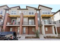 Attractive townhome with brick facade, outdoor balcony, and well-maintained landscaping at 7812 W 43Rd Pl, Wheat Ridge, CO 80033