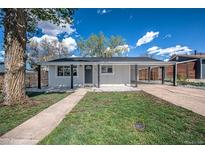 Charming home with a well-maintained front yard and a covered carport at 3940 S Hazel Ct, Englewood, CO 80110