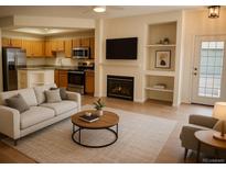 Cozy living room with fireplace, built-in shelving, and wood flooring provides a comfortable retreat at 2980 W Centennial Dr # L, Littleton, CO 80123