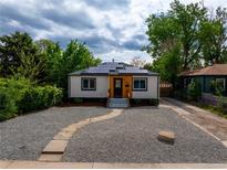 Charming home featuring solar panels, gravel landscaping, and a welcoming front entrance at 3636 Ames St, Wheat Ridge, CO 80212
