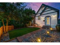 Charming home with a brick walkway, rock landscaping, and a well-maintained lawn at 720 Lipan St, Denver, CO 80204