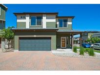 Charming two-story home with a front garage and a welcoming entrance with pleasant, easy-to-maintain landscaping at 19120 E 54Th Pl, Denver, CO 80249