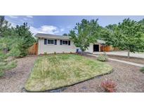 Ranch home with well-manicured lawn and walkway at 9303 W 66Th Pl, Arvada, CO 80004