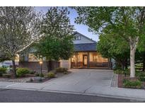 Charming home with landscaped front yard, covered porch, and a welcoming entrance at 15333 Heritage Cir, Thornton, CO 80602