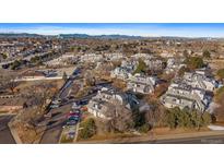 Wide aerial shot of condo neighborhood with mountain backdrop on clear day at 8701 Huron # 207, Thornton, CO 80260