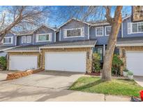 Charming townhome featuring a two-car garage, stone accents, and a well-maintained front yard in a desirable community at 8312 S Saulsbury St # C, Littleton, CO 80128