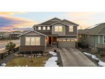 Two story home featuring a stone facade, well maintained lawn, and an attached two car garage at 3014 Furthermore Ln, Castle Rock, CO 80108