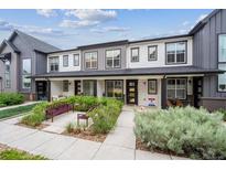 Charming townhome featuring a covered front porch and well-maintained landscaping at 9269 Garnett St # C, Arvada, CO 80007