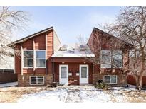 Charming townhouse with a unique design and a well-maintained front yard with a pair of doors and visible house numbers at 2664 S Grant St, Denver, CO 80210