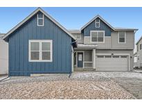 Charming two-story home featuring a blue and gray color scheme and an attached two-car garage at 39440 Congress Ln, Elizabeth, CO 80107