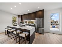 Modern kitchen with stainless steel appliances and an island at 5098 E Donald, Denver, CO 80222